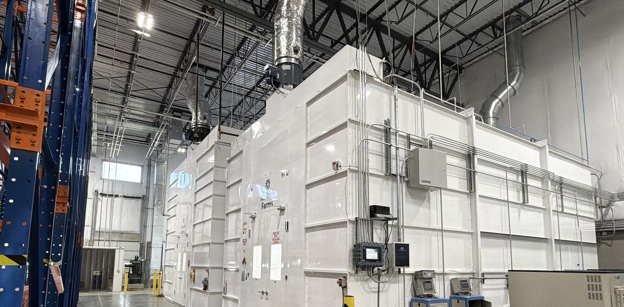 The paneled cleanroom built inside the Loveland warehouse, with bollards and control panels outside