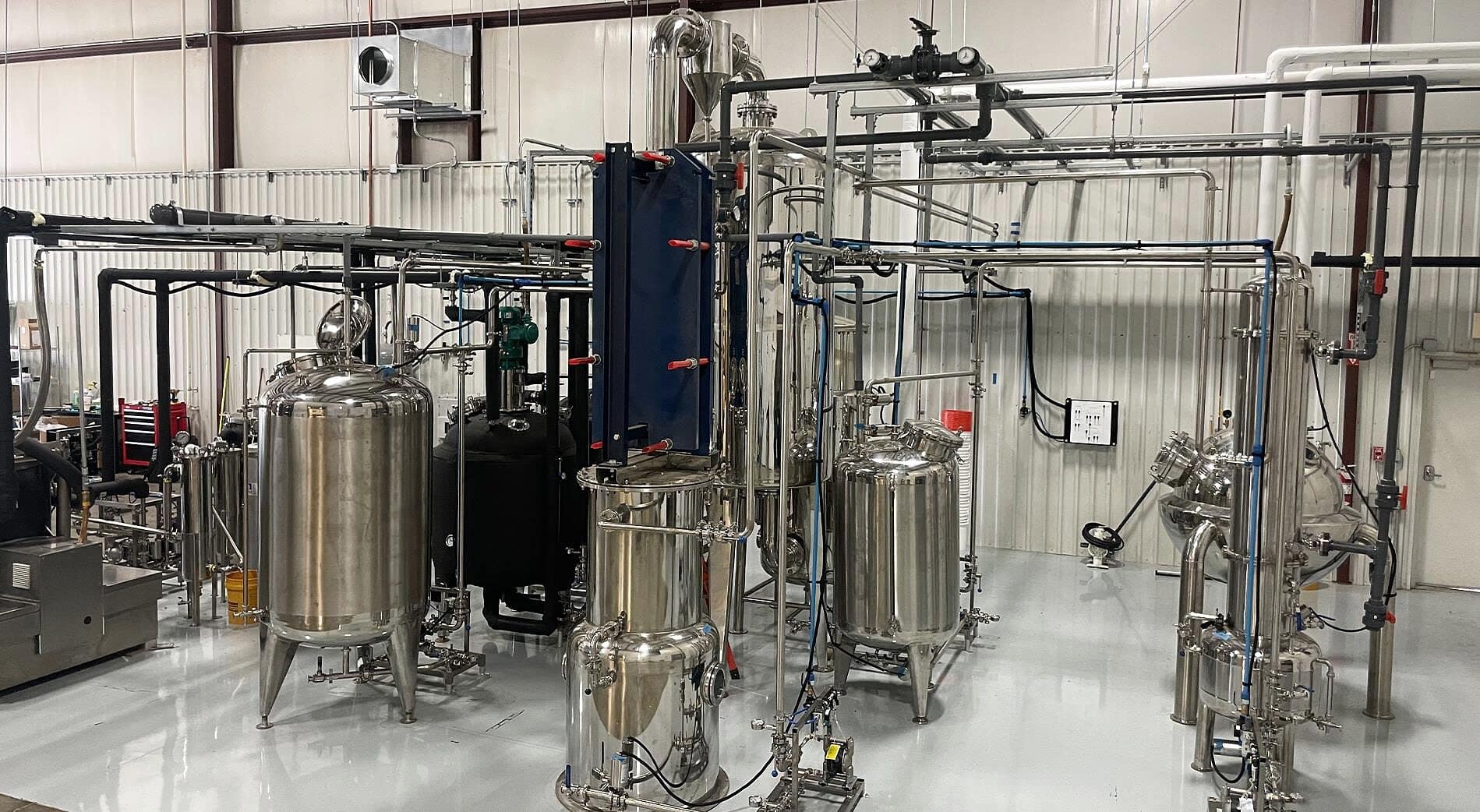 A cold-ethanol line: tanks, plate heat exchanger and falling-film evaporator